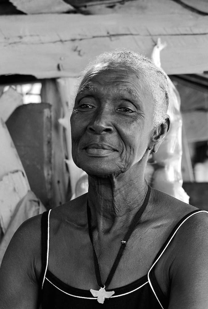 5 Queen I met Queen while driving through a street filled with roadside sellers in the community of Bog Walk, St. Catherine. Queen sells some of the sweetest sugarcane one could ever hope to taste, and if you're lucky you can enjoy a little chit-chat with her, as she has a welcoming humor about life in Jamaica.
