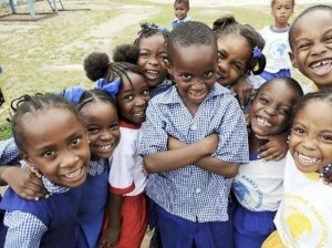Students of Advent Deliverance Early Childhood Institution in Kingston smile for the camera. - Image via - jamaica-gleaner.com