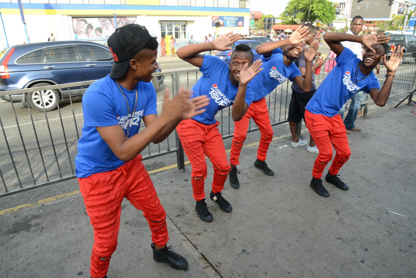 The male dancers from the Pepsi promo team hit their marks as they deliver a sharp routine at the Pepsi Refresh Tour held outside the Half-Way-Tree Transport Centre last Friday. 